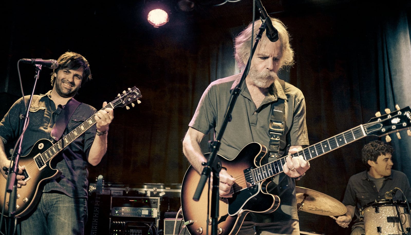 Nathan Dale and Bob Weir playing electric guitars with Zack Bowden on drums at Sweetwater Music Hall in 2012