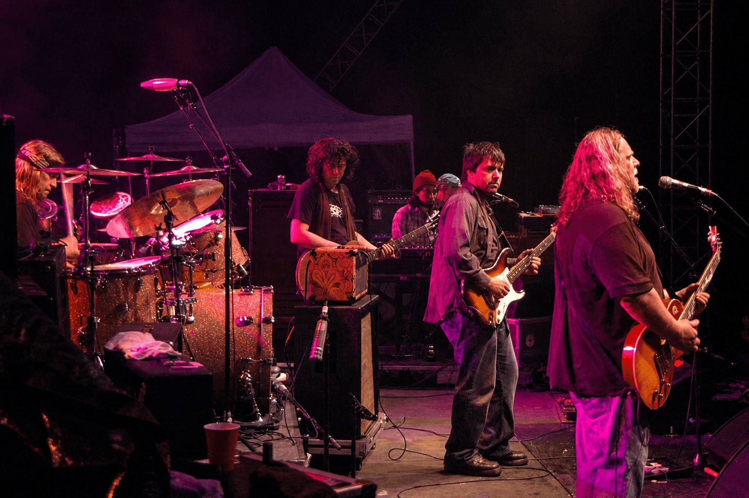 Nathan Dale playing electric guitar onstage with Warren Haynes and Gov't Mule on August 15, 2010