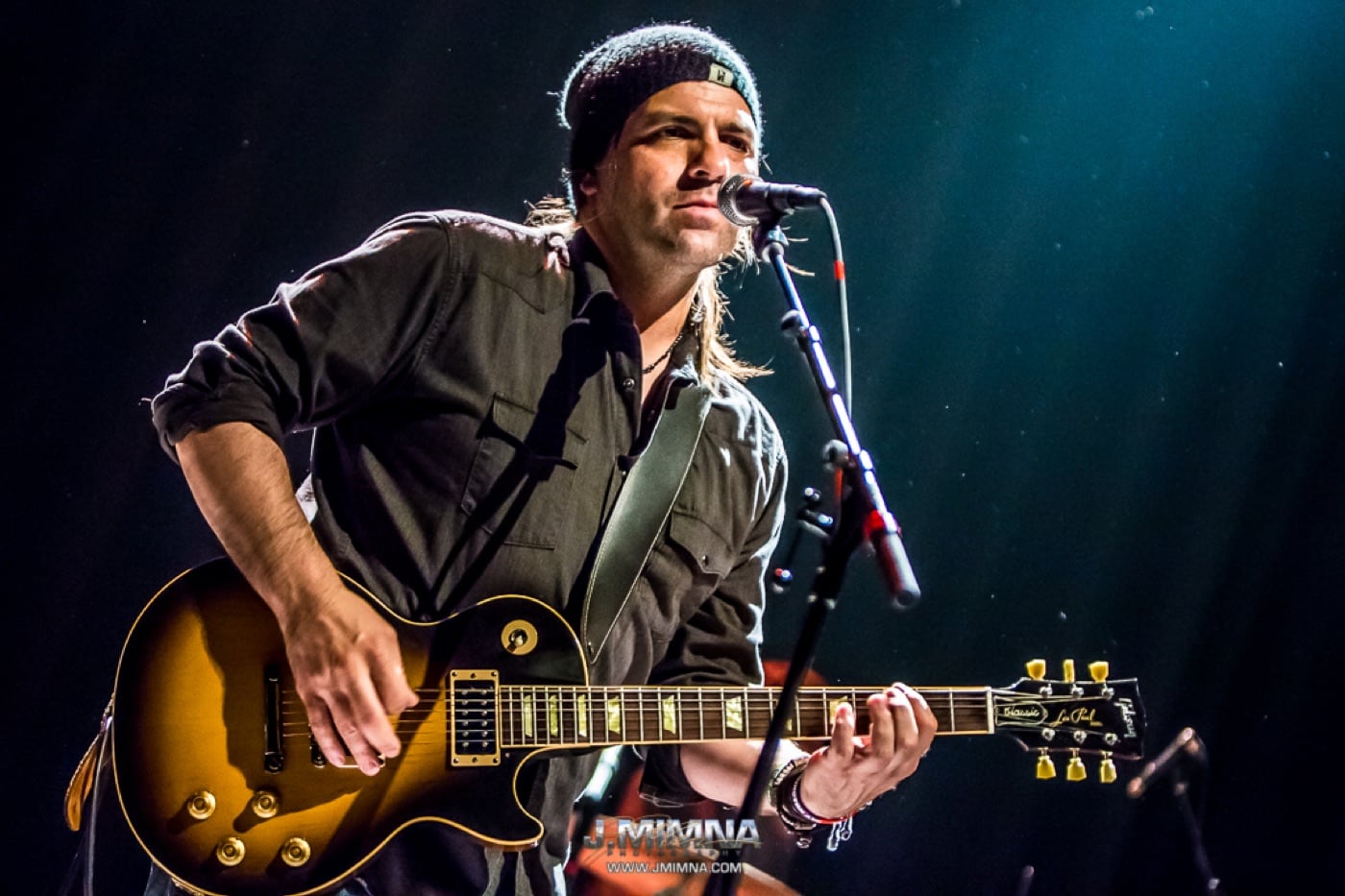 Nathan Dale singing and playing a Les Paul onstage