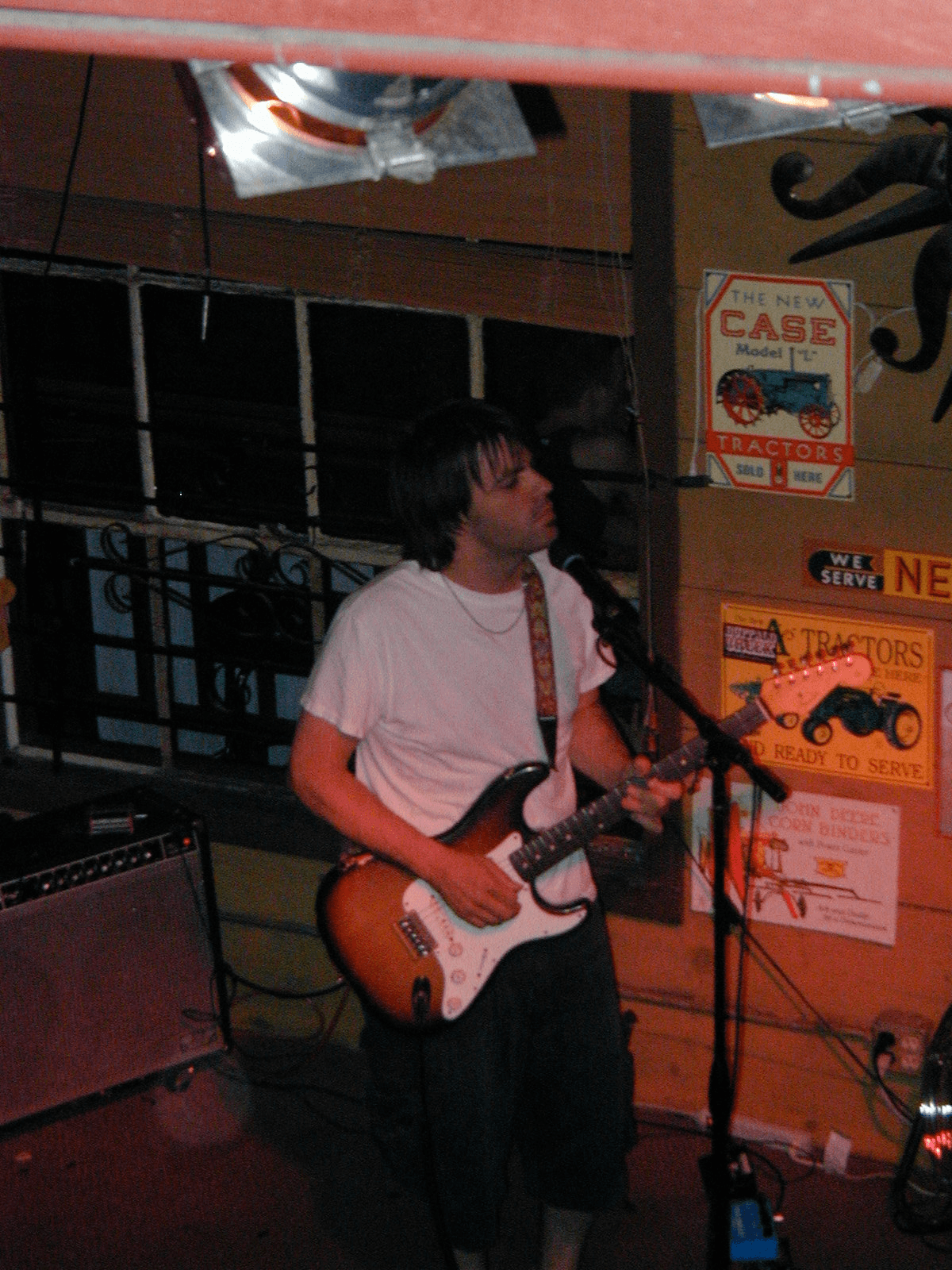 Nathan Dale playing guitar at the Powerhouse Pub Sunday jam session on July 20, 2003