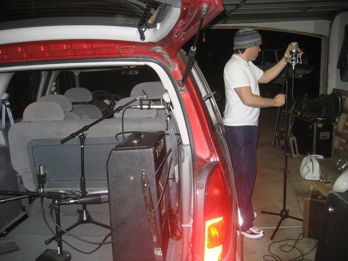 Nathan Dale positioning a microphone beside the amplifier and microphone array inside the open Dodge Caravan during the March 14, 2008 recording session